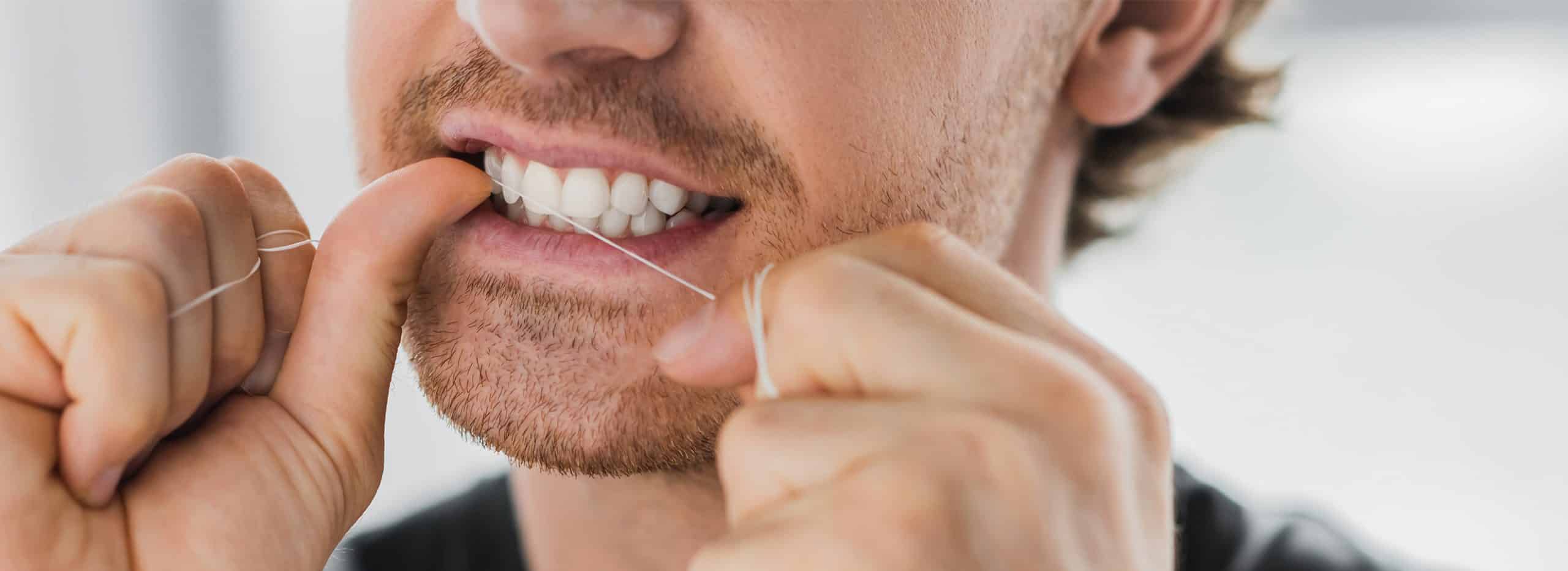 man flossing his teeth in mount pleasant wisconsin