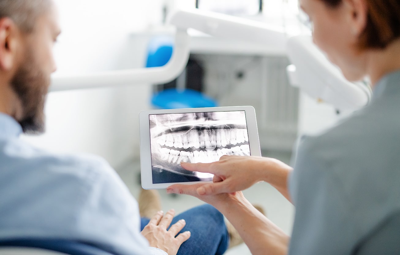 dental patient with hygienist showing tooth xrays at oxford dental