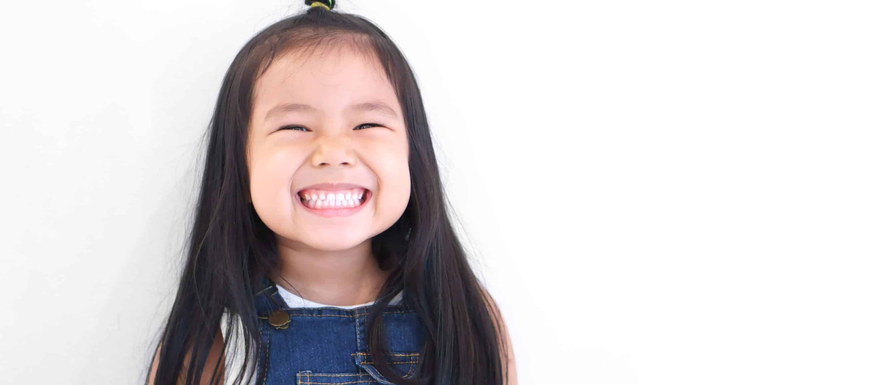 girl smiling showing her teeth after pediatric dentist appointment at oxford dental