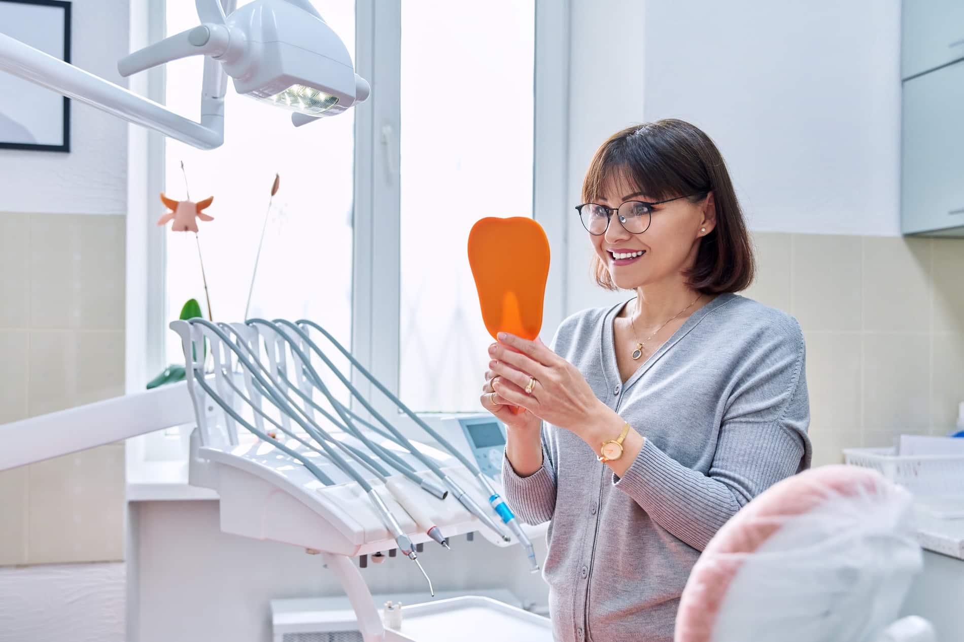 patient happy with her single tooth implant procedure at oxford dental in mount pleasant wi