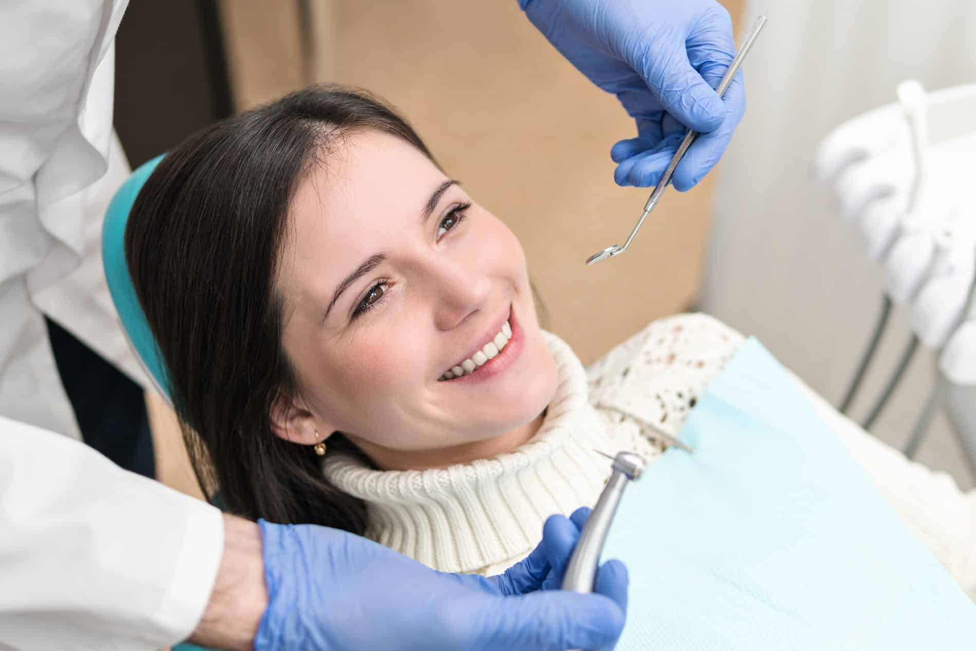 patient happy with her multi-tooth implant procedure at oxford dental in mount pleasant wi